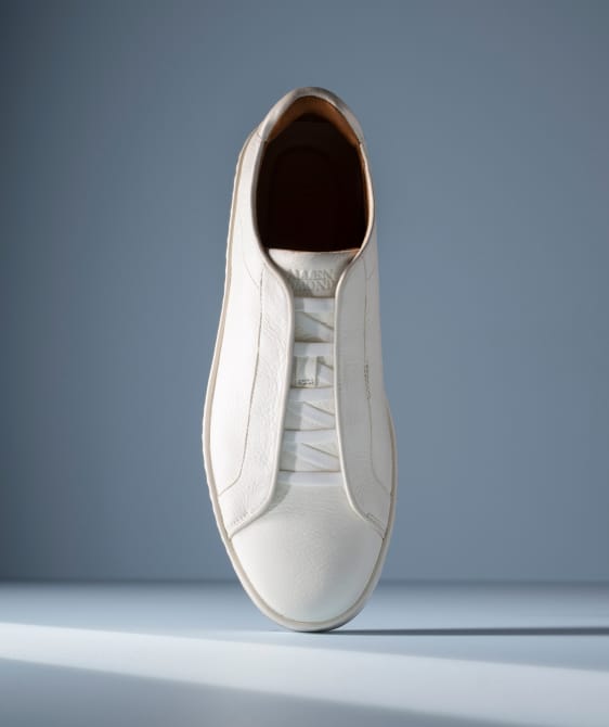 Men’s gray textured leather sneaker with tan rubber sole and brown leather lining
